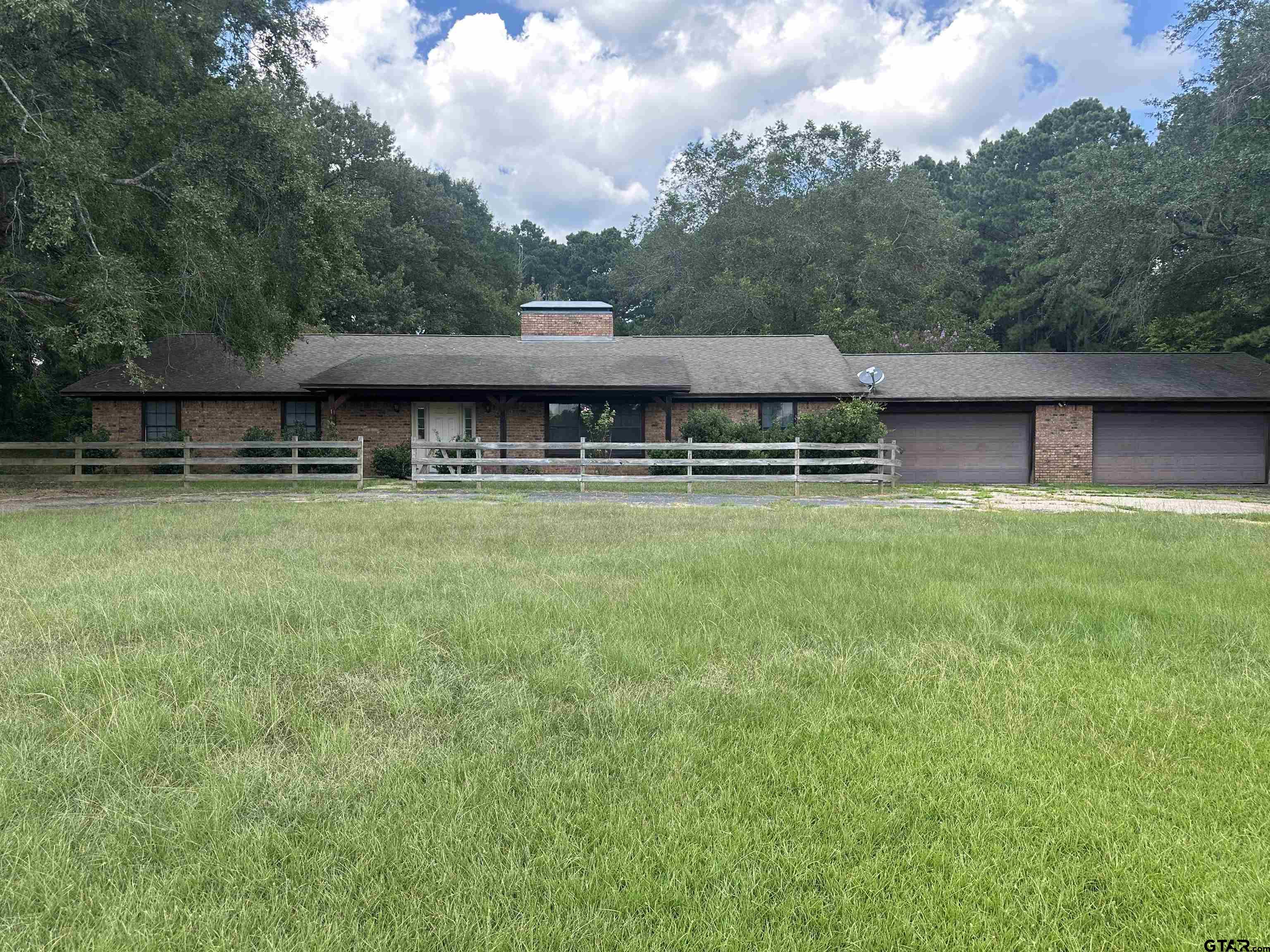 141 Meador Road Kilgore, TX 75662 - Photo 2 of 14 a view of a swimming pool and lounge chairs in th patio