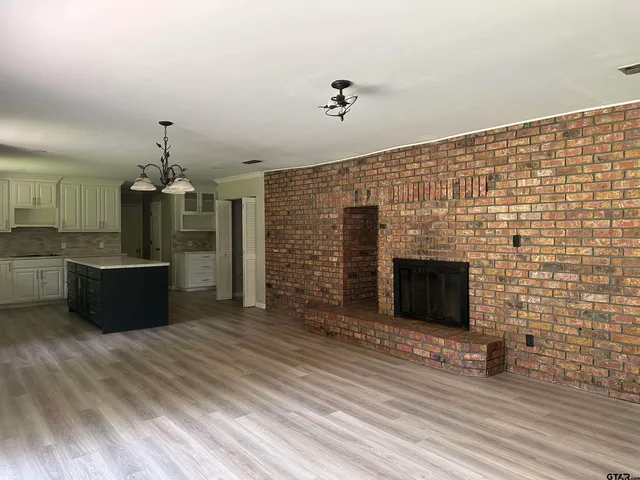a spacious bathroom with a granite countertop sink a mirror and a bathtub