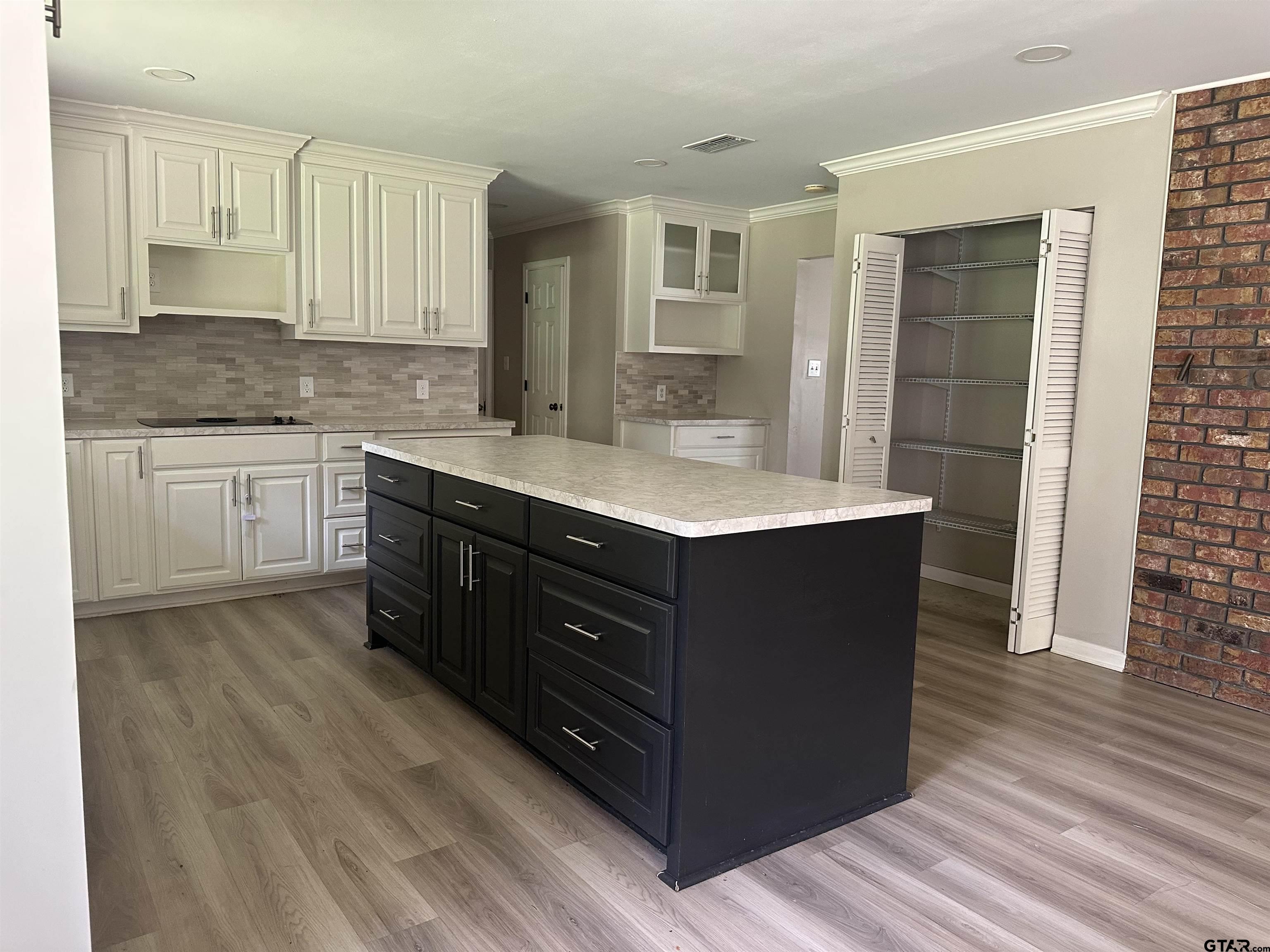 141 Meador Road Kilgore, TX 75662 - Photo 7 of 14 a spacious bathroom with a granite countertop sink a mirror and a bathtub