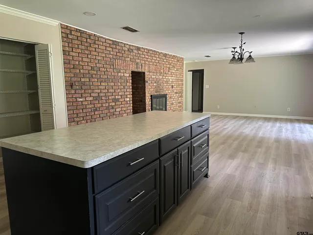 a kitchen with a wooden floor and a refrigerator