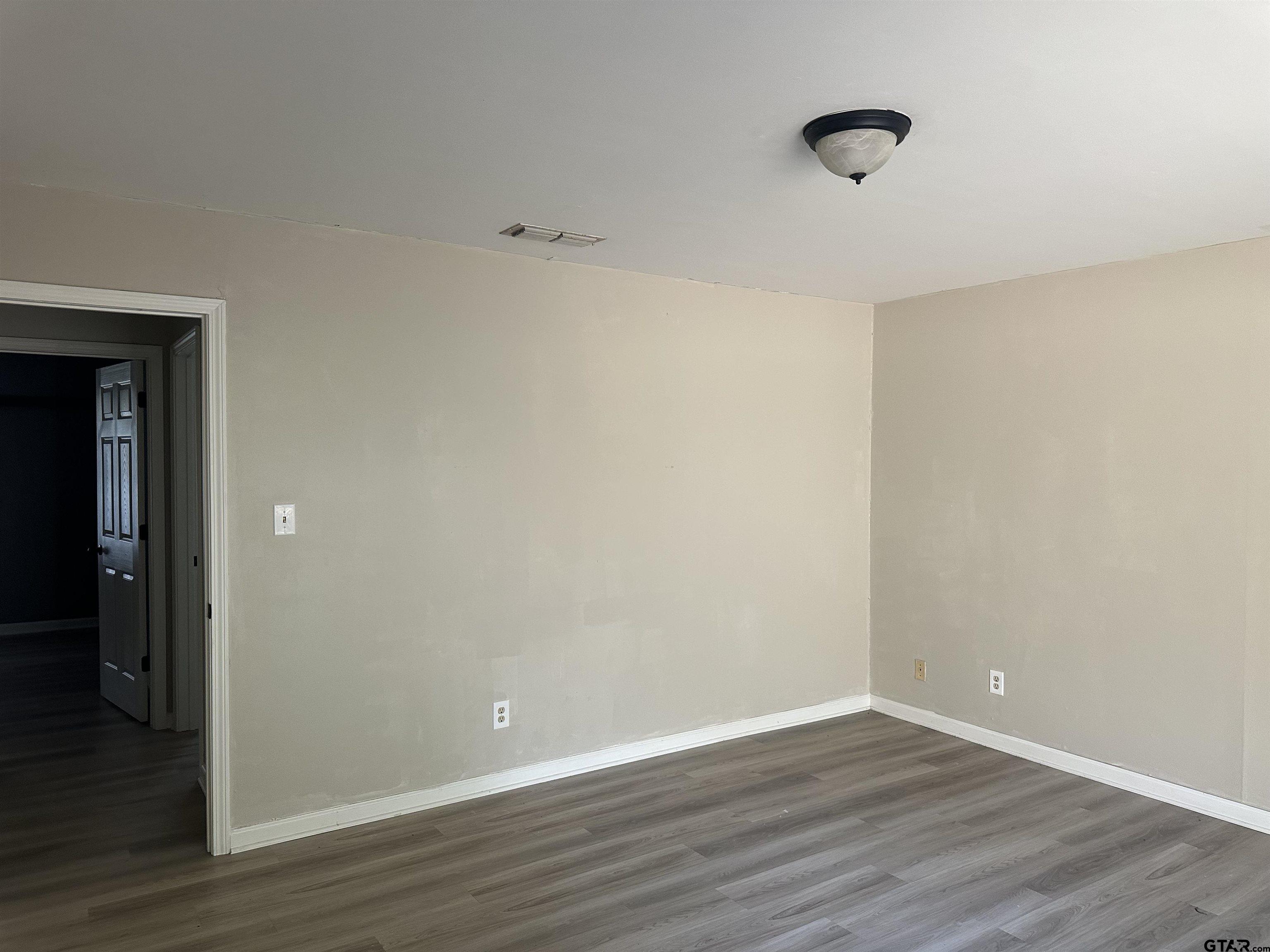 141 Meador Road Kilgore, TX 75662 - Photo 10 of 14 a view of an empty room with wooden floor
