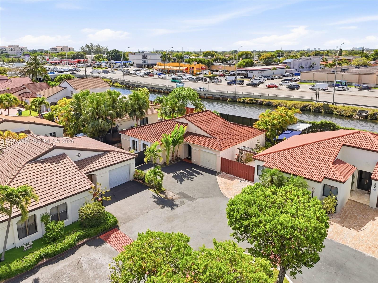 an aerial view of a house with garden space and street view