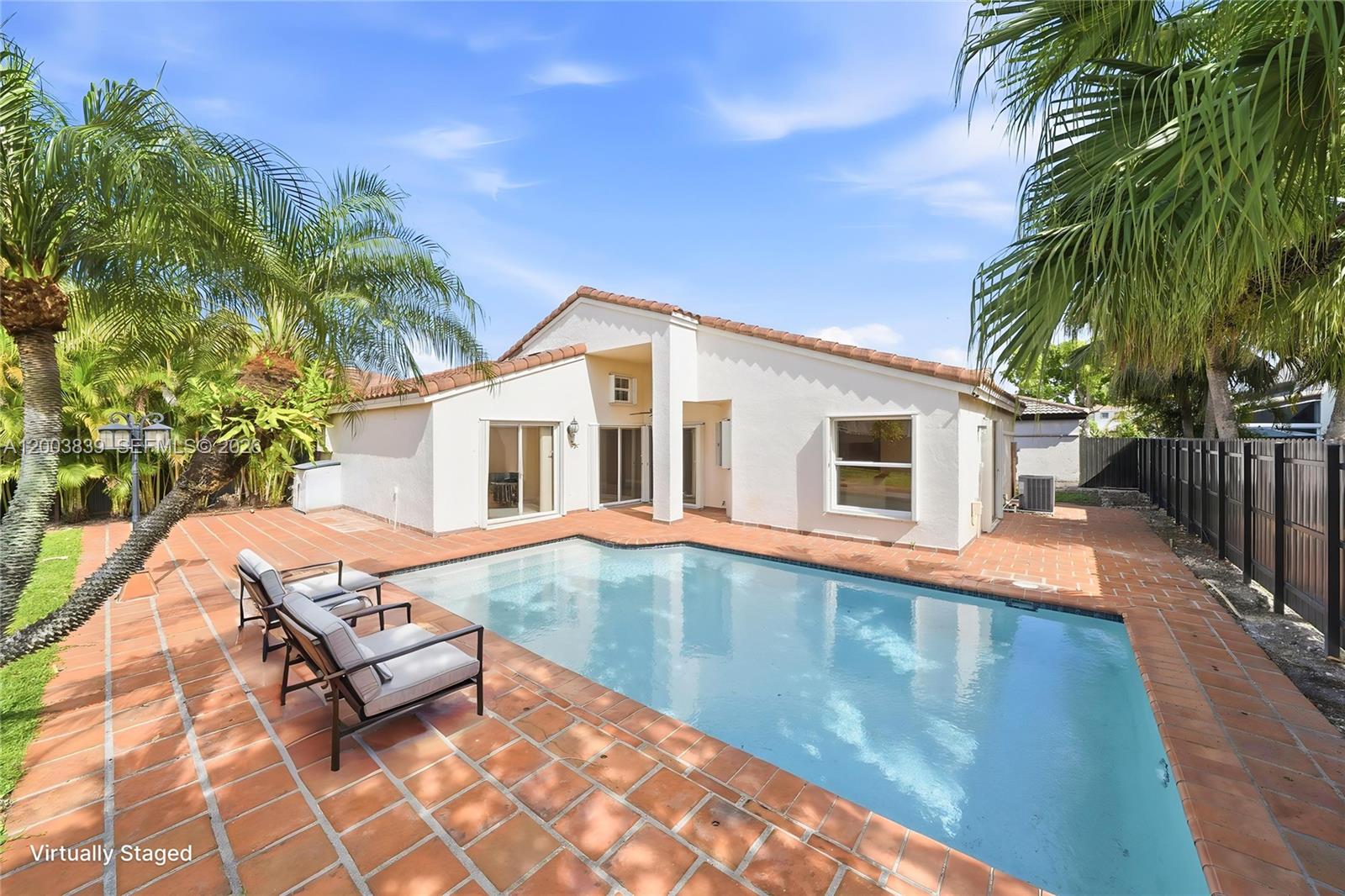 631 Southwest 88th Court Miami, FL 33174 - Photo 16 of 28 a swimming pool with outdoor seating and yard