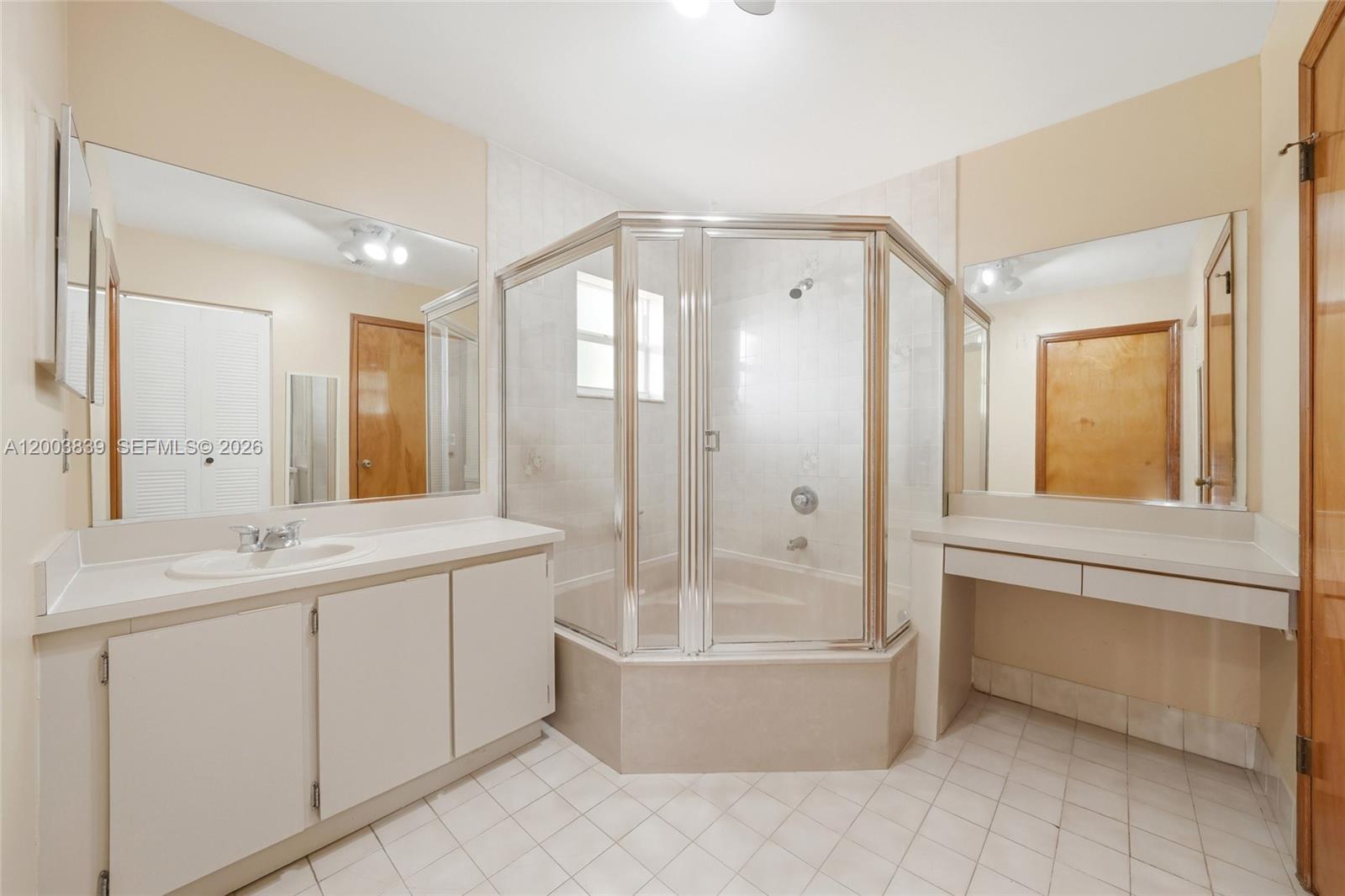 631 Southwest 88th Court Miami, FL 33174 - Photo 22 of 28 a bathroom with a tub sink mirror and