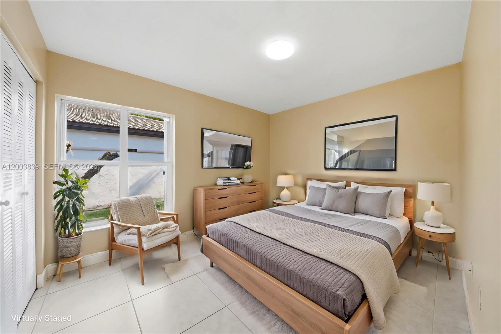 631 Southwest 88th Court Miami, FL 33174 - Photo 23 of 28 a bedroom with a bed and a painting on the wall
