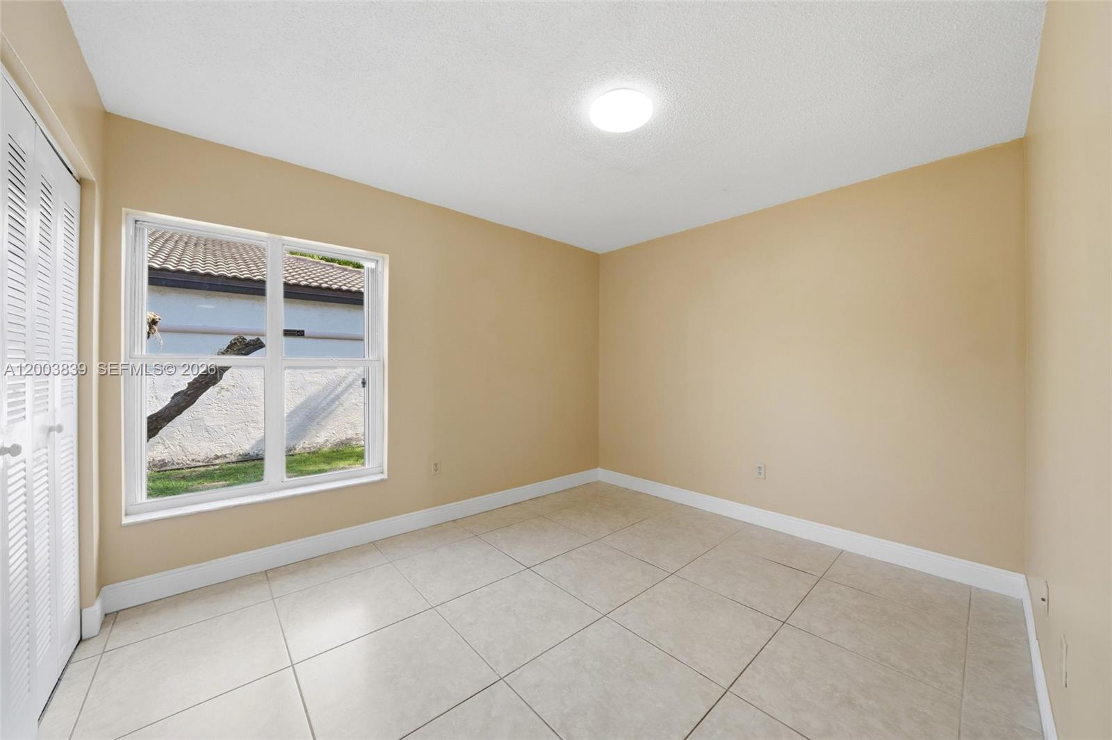 631 Southwest 88th Court Miami, FL 33174 - Photo 24 of 28 an empty room with a window