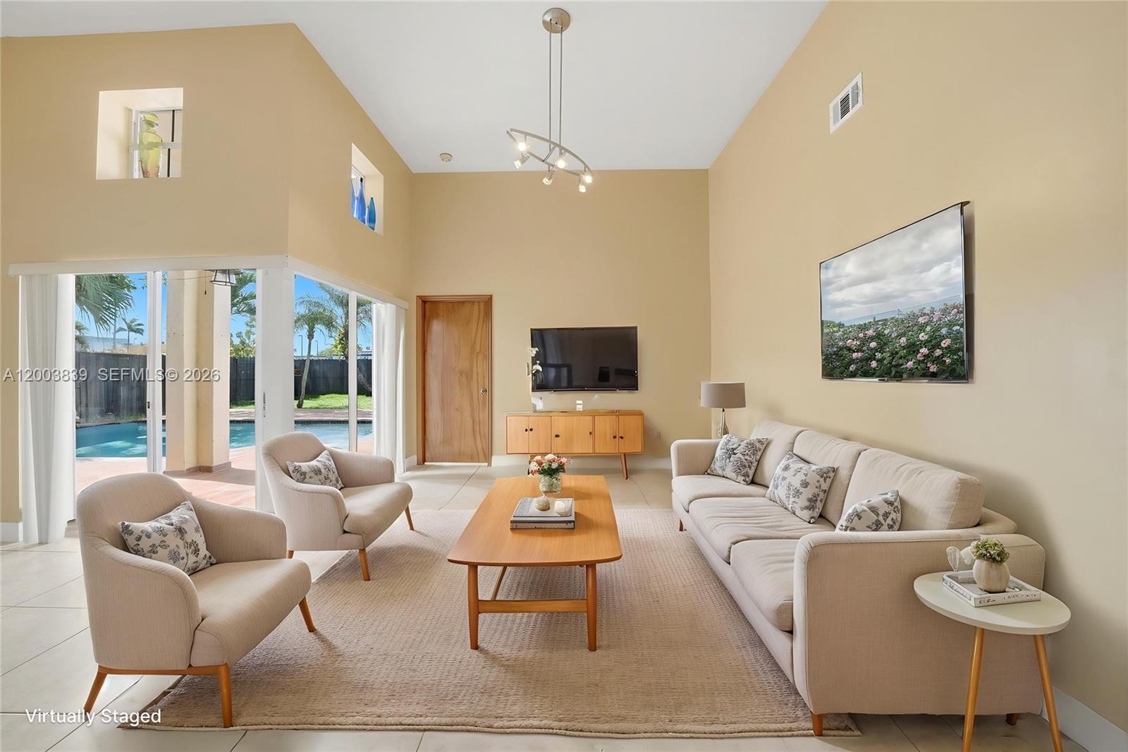 631 Southwest 88th Court Miami, FL 33174 - Photo 8 of 28 a living room with furniture and a flat screen tv
