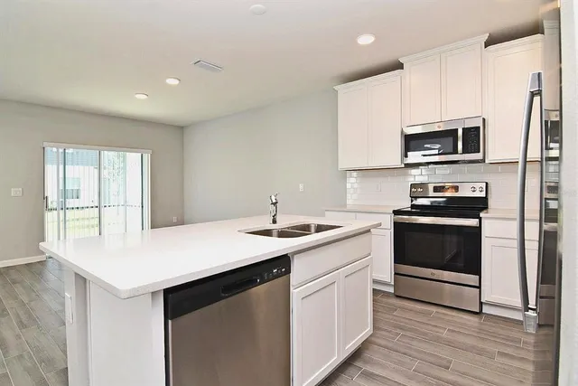 a kitchen with a sink stove and microwave
