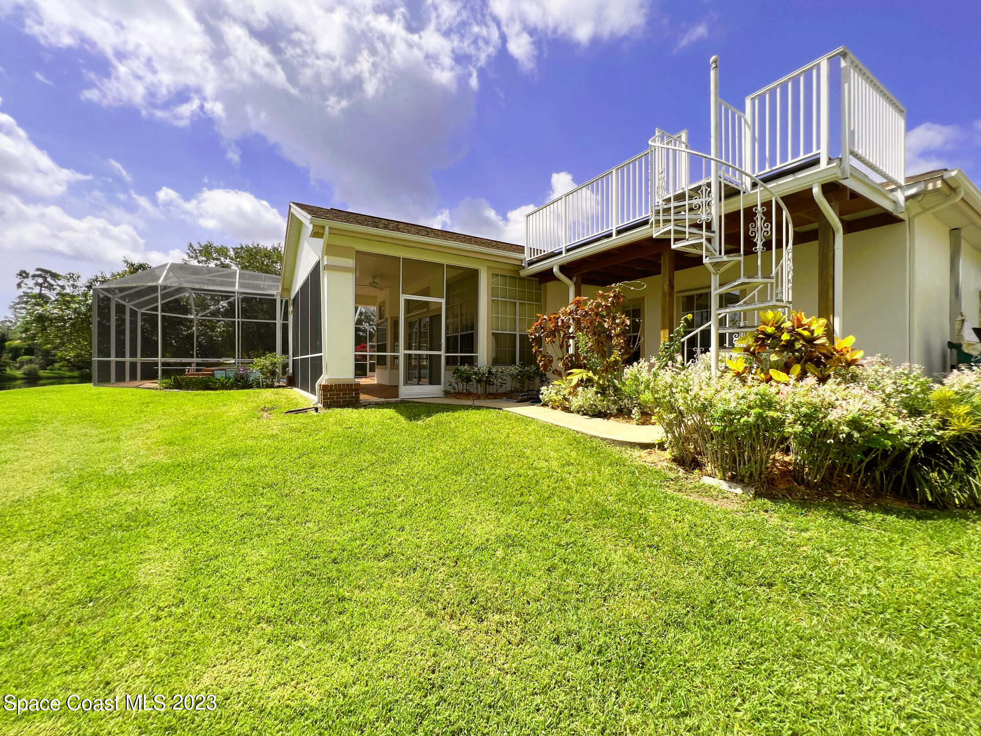 3475 Big Pine Road Melbourne, FL 32934 - Photo 3 of 28 a view of a house with a big yard and potted plants