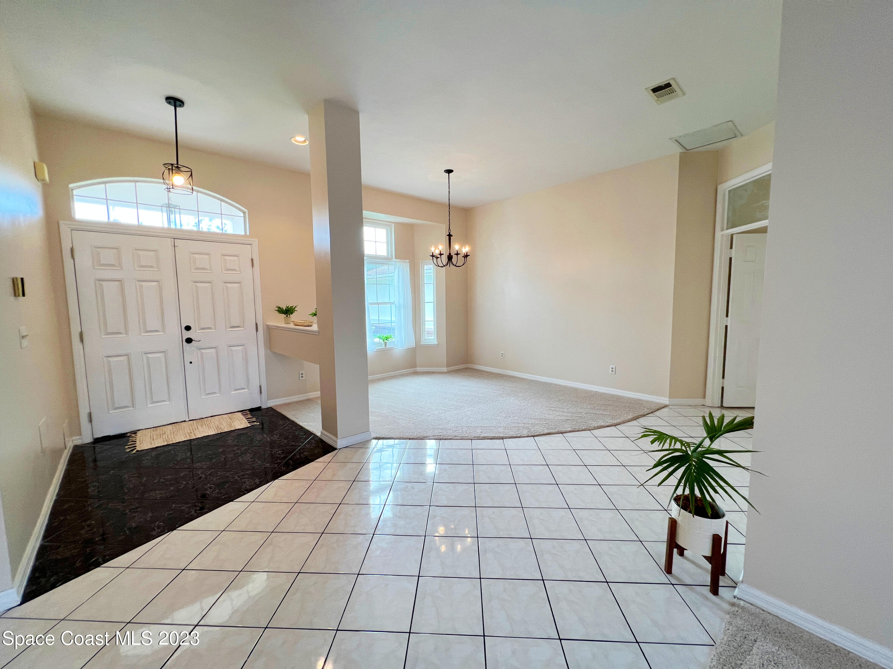 3475 Big Pine Road Melbourne, FL 32934 - Photo 8 of 28 a view of a hallway with a chandelier