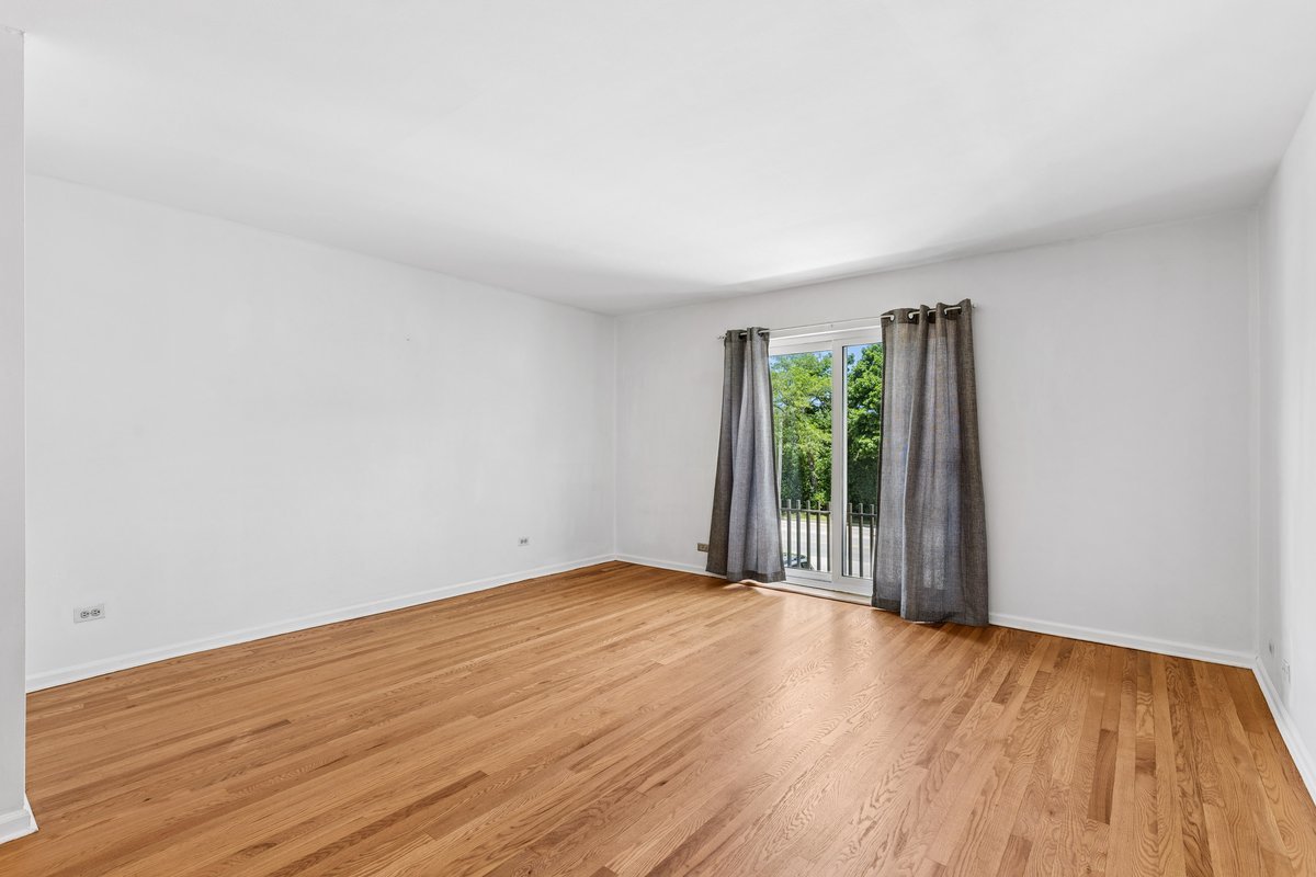 140 Green Bay Road, Unit 2 Glencoe, IL 60022 - Photo 6 of 28 a view of an empty room with wooden floor and a window