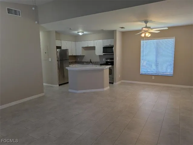 a view of kitchen and refrigerator