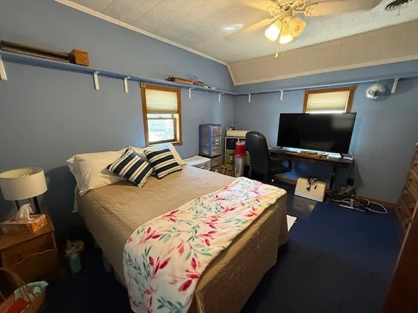a bedroom with bed and window