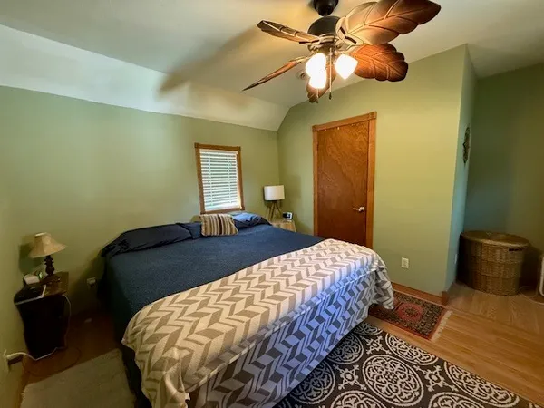 a bedroom with a bed and ceiling fan
