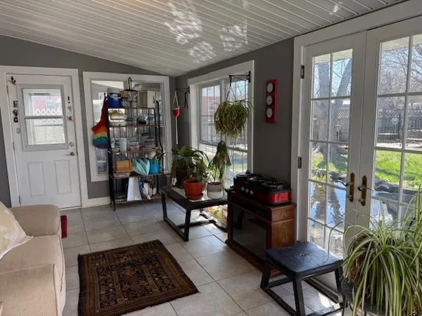 a living room with furniture and a potted plant