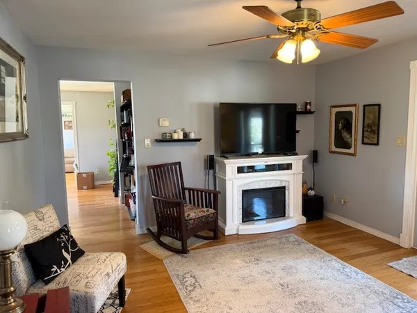 a living room with furniture fireplace and flat screen tv