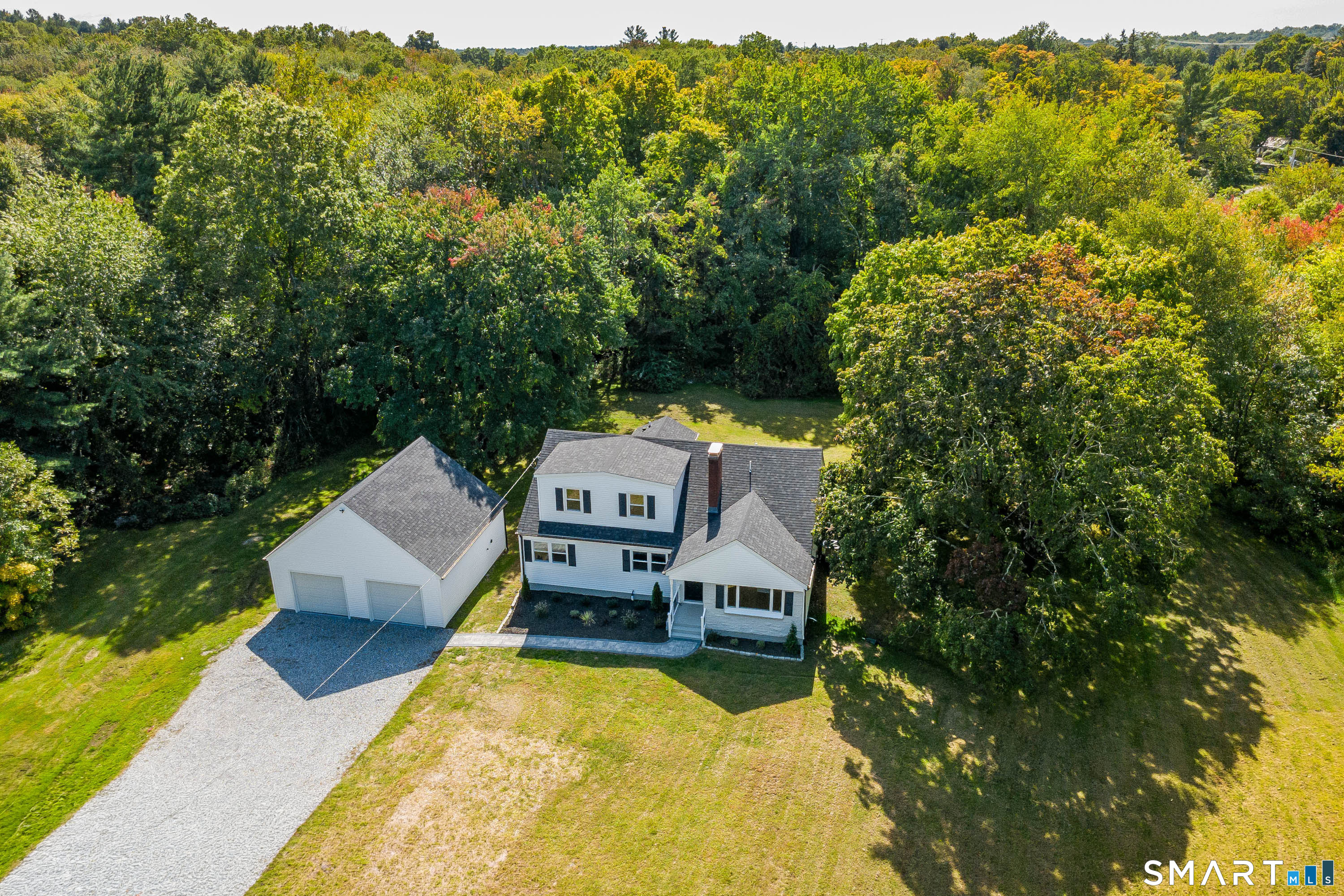 34 Rimmon Road Woodbridge, CT 06525 - Photo 38 of 40 Elevated view highlighting the home, garage and surrounding mature landscape.