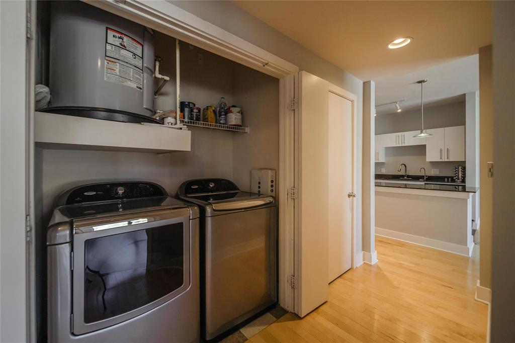 4414 Cedar Springs Road, Unit 214 Dallas, TX 75219 - Photo 13 of 29 Laundry area with light wood-type flooring, water heater, recessed lighting, and separate washer and dryer