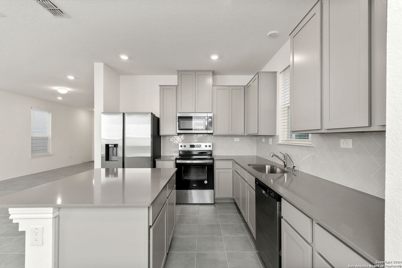 14839 Vance Jackson Road, Unit 910 San Antonio, TX 78249 - Photo 12 of 29 a kitchen with stainless steel appliances granite countertop a sink a stove and a refrigerator