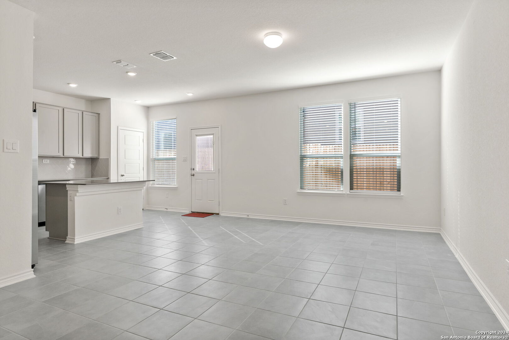 14839 Vance Jackson Road, Unit 910 San Antonio, TX 78249 - Photo 14 of 29 a view of an empty room with kitchen and window