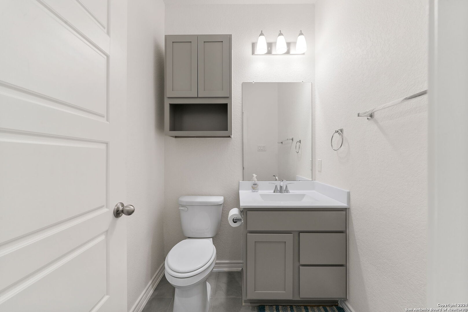14839 Vance Jackson Road, Unit 910 San Antonio, TX 78249 - Photo 16 of 29 a bathroom with a toilet sink and mirror