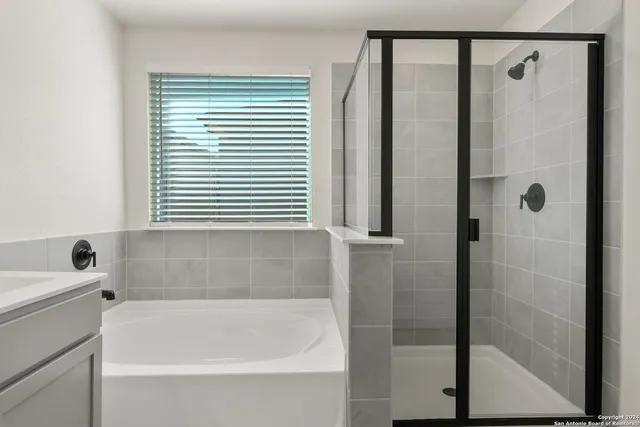 a bathroom with a bathtub and a shower