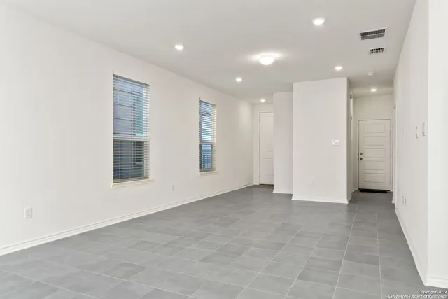 an empty room with windows and closet