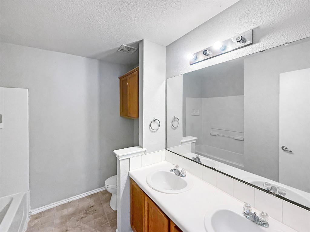 4516 Felicity Lane Austin, TX 78725 - Photo 12 of 15 a bathroom with a sink and a mirror