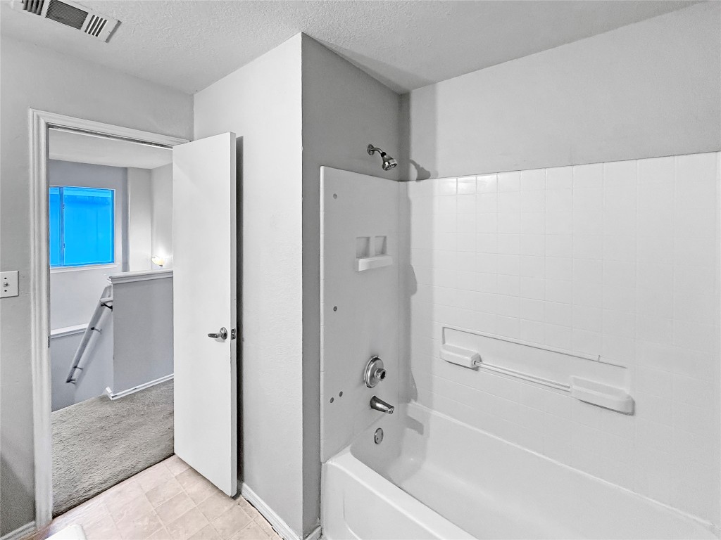 4516 Felicity Lane Austin, TX 78725 - Photo 13 of 15 a bathroom with a bathtub and a shower