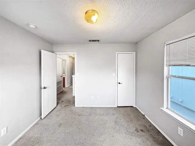 a view of a hallway to a bedroom