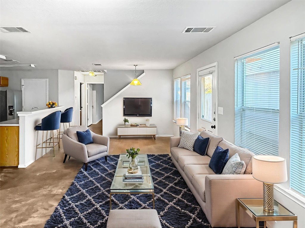 4516 Felicity Lane Austin, TX 78725 - Photo 2 of 15 a living room with furniture or couch and a flat screen tv