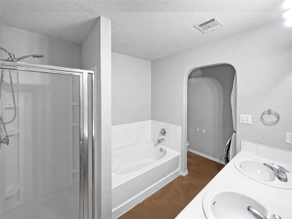 4516 Felicity Lane Austin, TX 78725 - Photo 7 of 15 a bathroom with a tub sink and toilet