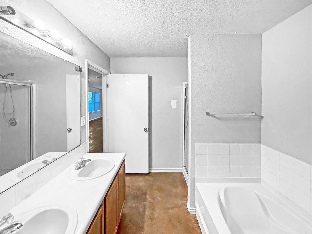 4516 Felicity Lane Austin, TX 78725 - Photo 8 of 15 a spacious bathroom with a tub shower and sink