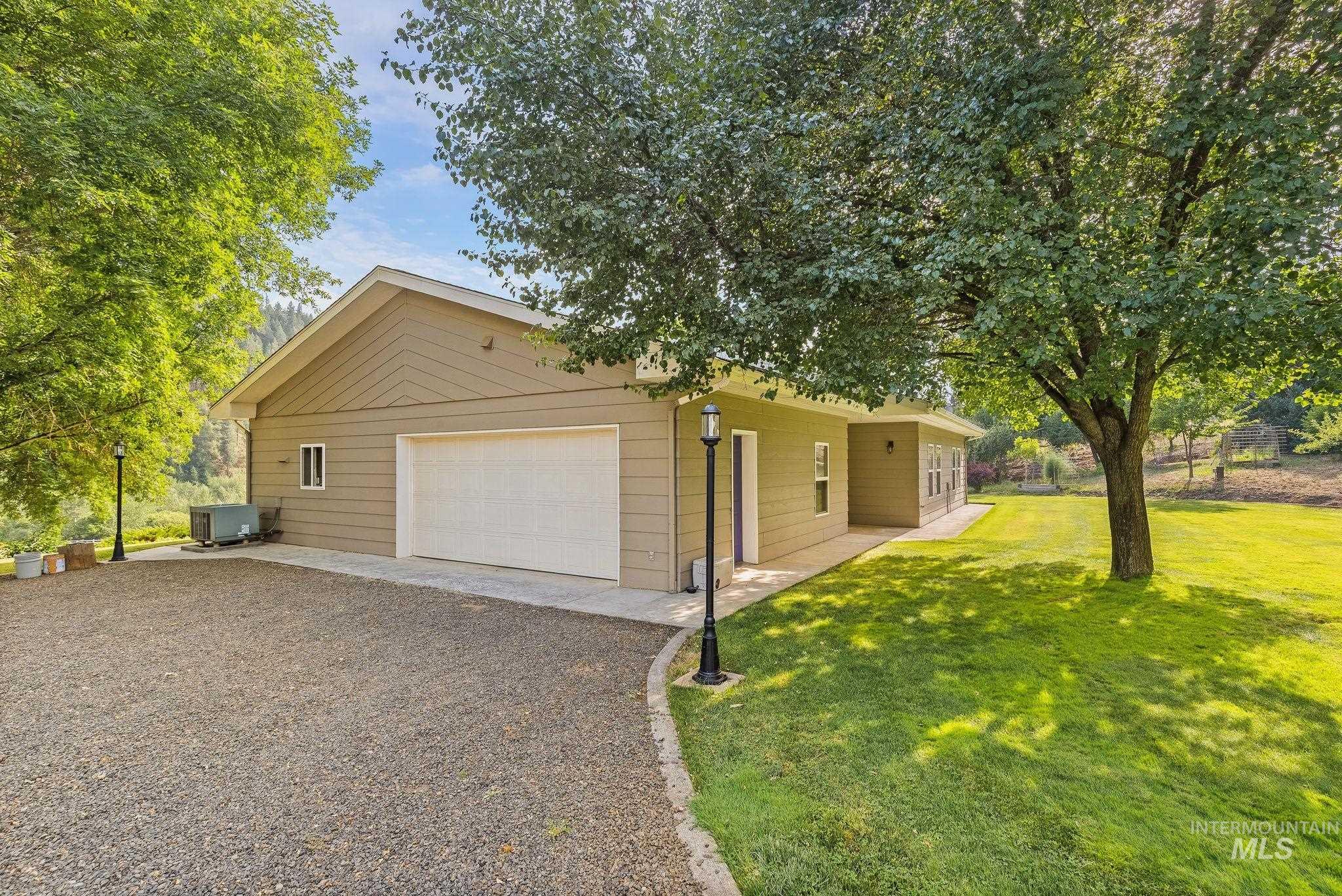 1091 Cedar Ridge Road Kendrick, ID 83537 - Photo 2 of 48 Detached garage structure with a light beige exterior siding and a single white overhead door