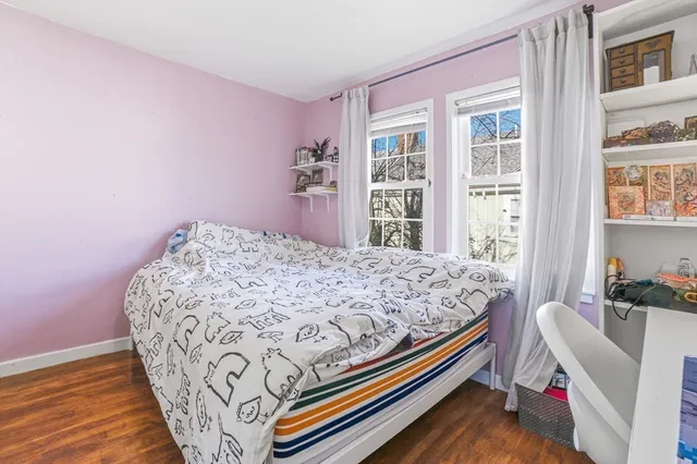 a bedroom with a bed and flat screen tv