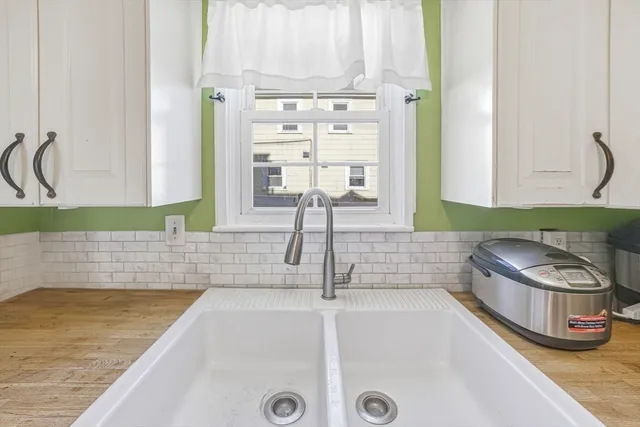 a kitchen with a table and a clock on the wall