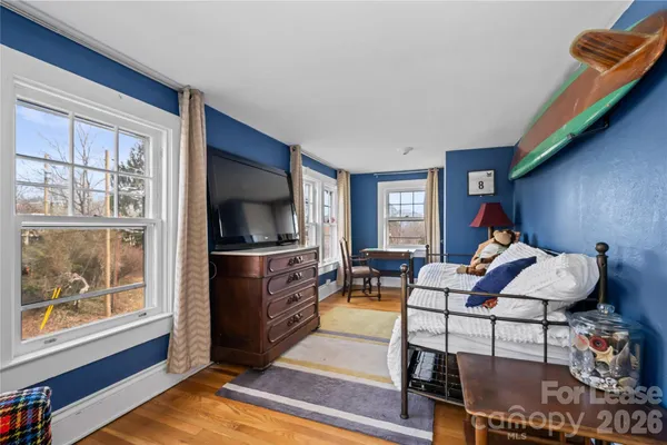 a living room with furniture a rug and a window