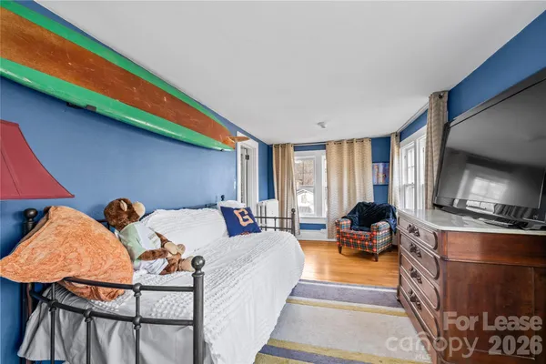 a bed room with furniture and a flat screen tv