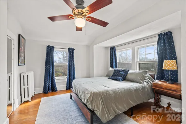 a bedroom with a large bed and a window