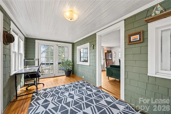a living room with furniture a flat screen tv and a large window