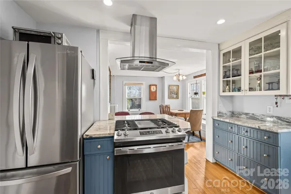 a kitchen with stainless steel appliances granite countertop a stove and a refrigerator