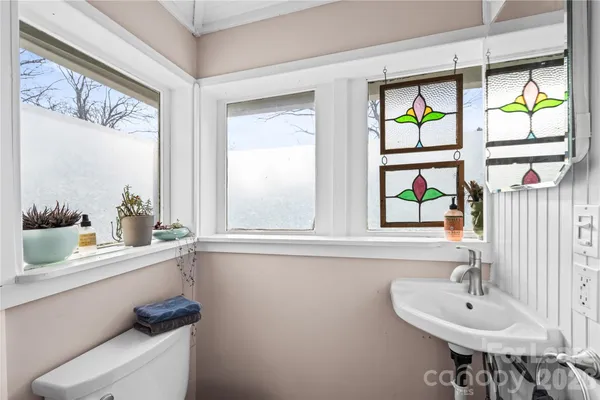a bathroom with a sink and a window