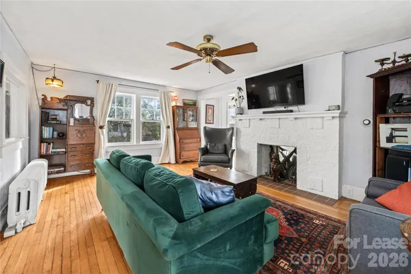 a living room with fireplace furniture and a flat screen tv