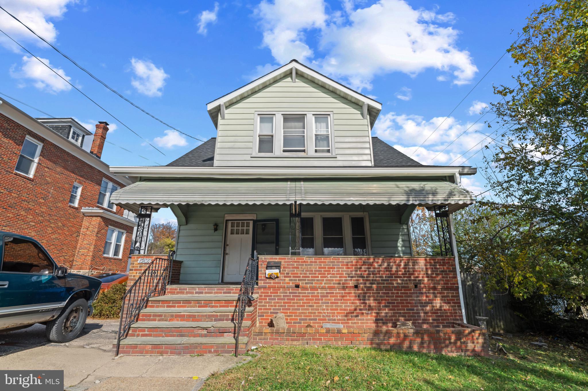 2908 Ailsa Avenue Baltimore, MD 21214 - Photo 1 of 29 a front view of a house with a garden