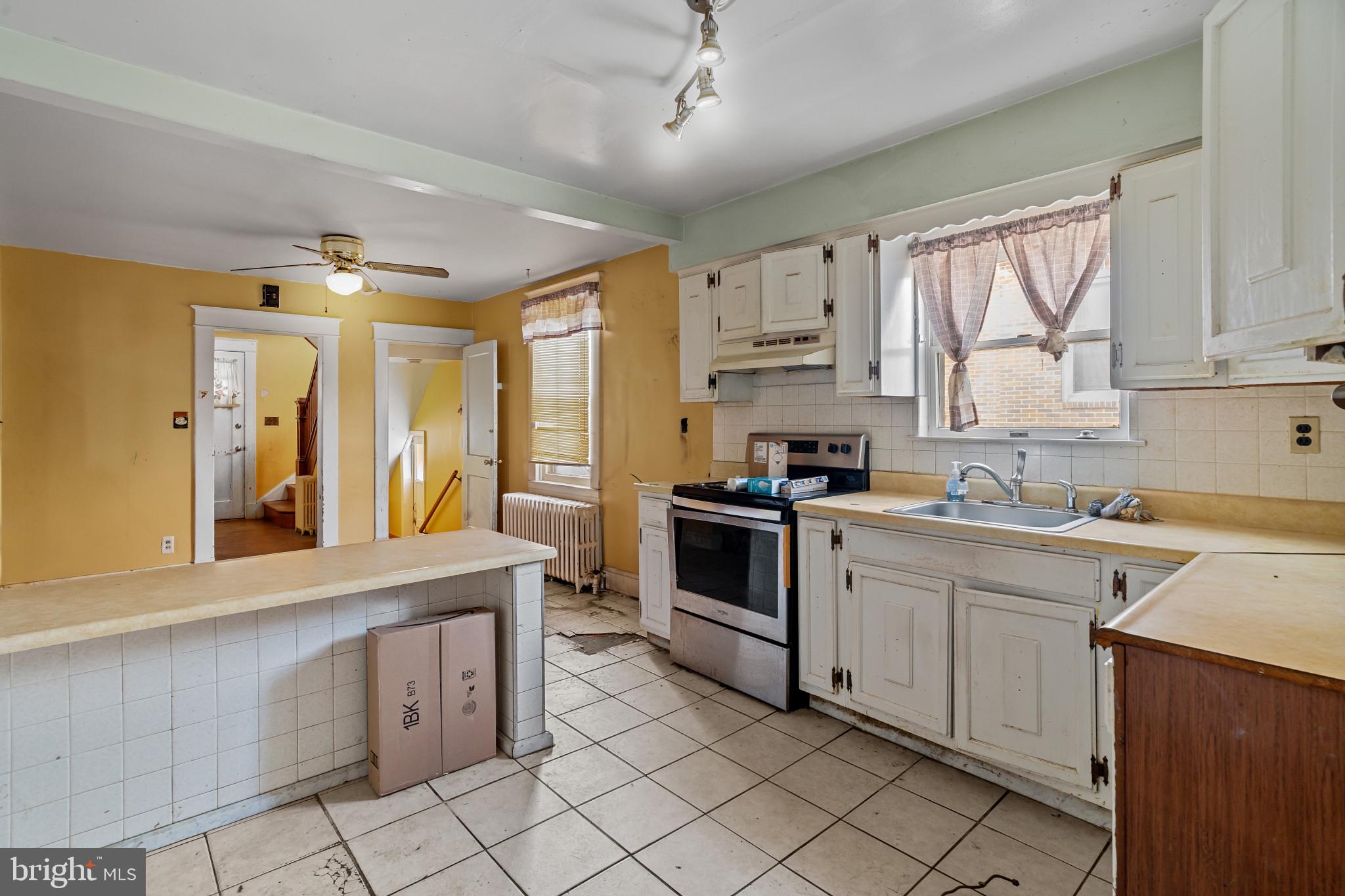 2908 Ailsa Avenue Baltimore, MD 21214 - Photo 11 of 29 a kitchen with a sink window and cabinets