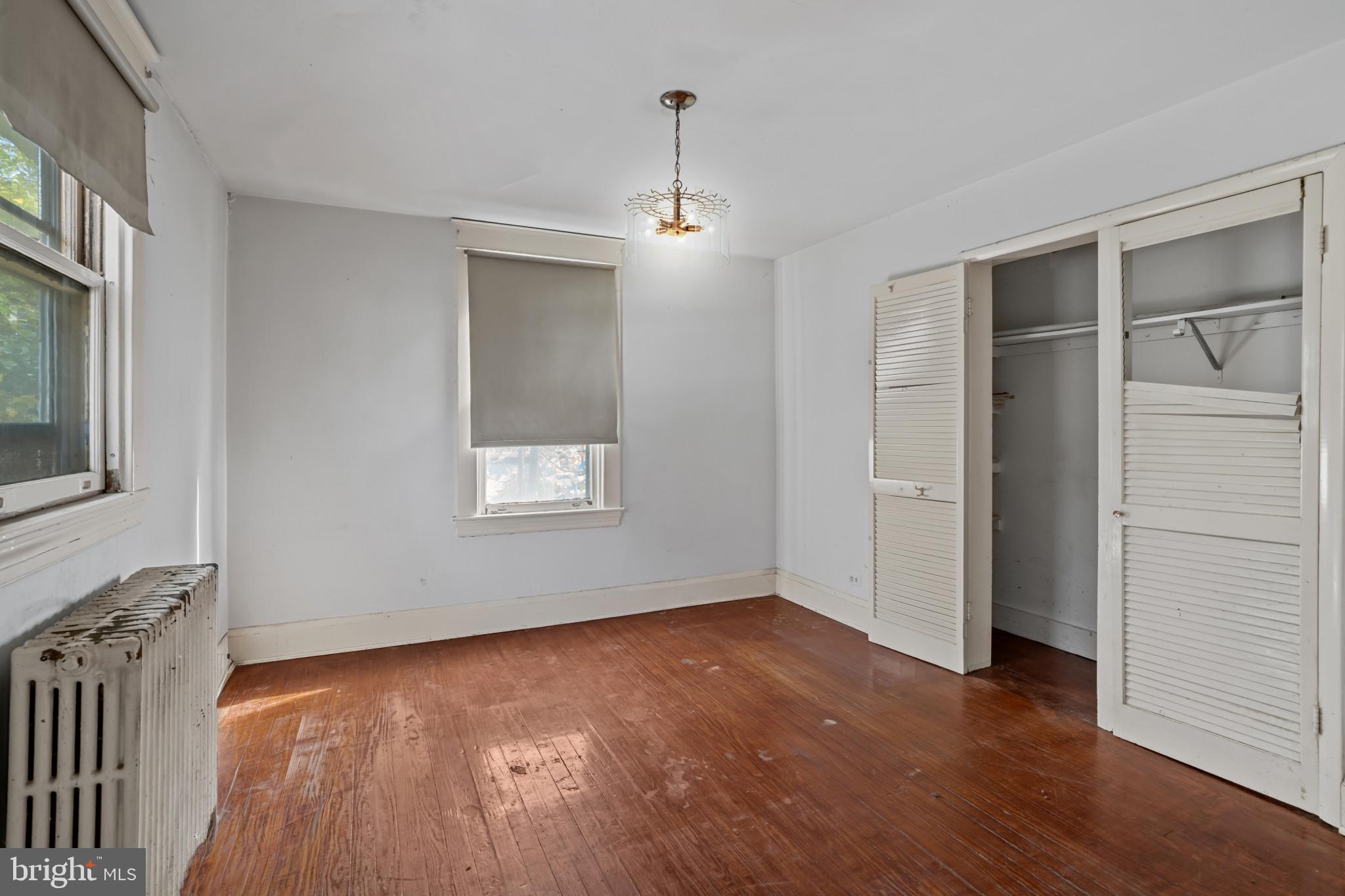 2908 Ailsa Avenue Baltimore, MD 21214 - Photo 13 of 29 an empty room with wooden floor and windows