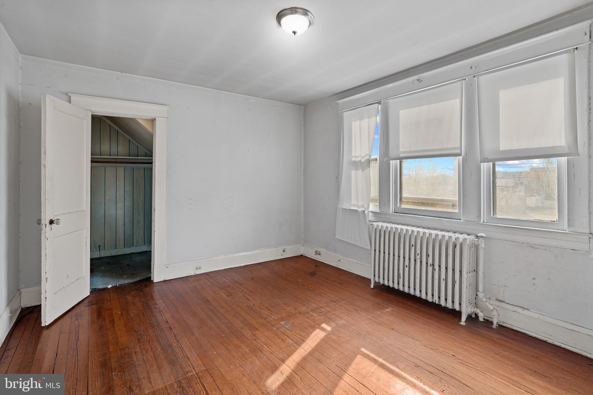 2908 Ailsa Avenue Baltimore, MD 21214 - Photo 18 of 29 an empty room with wooden floor and windows