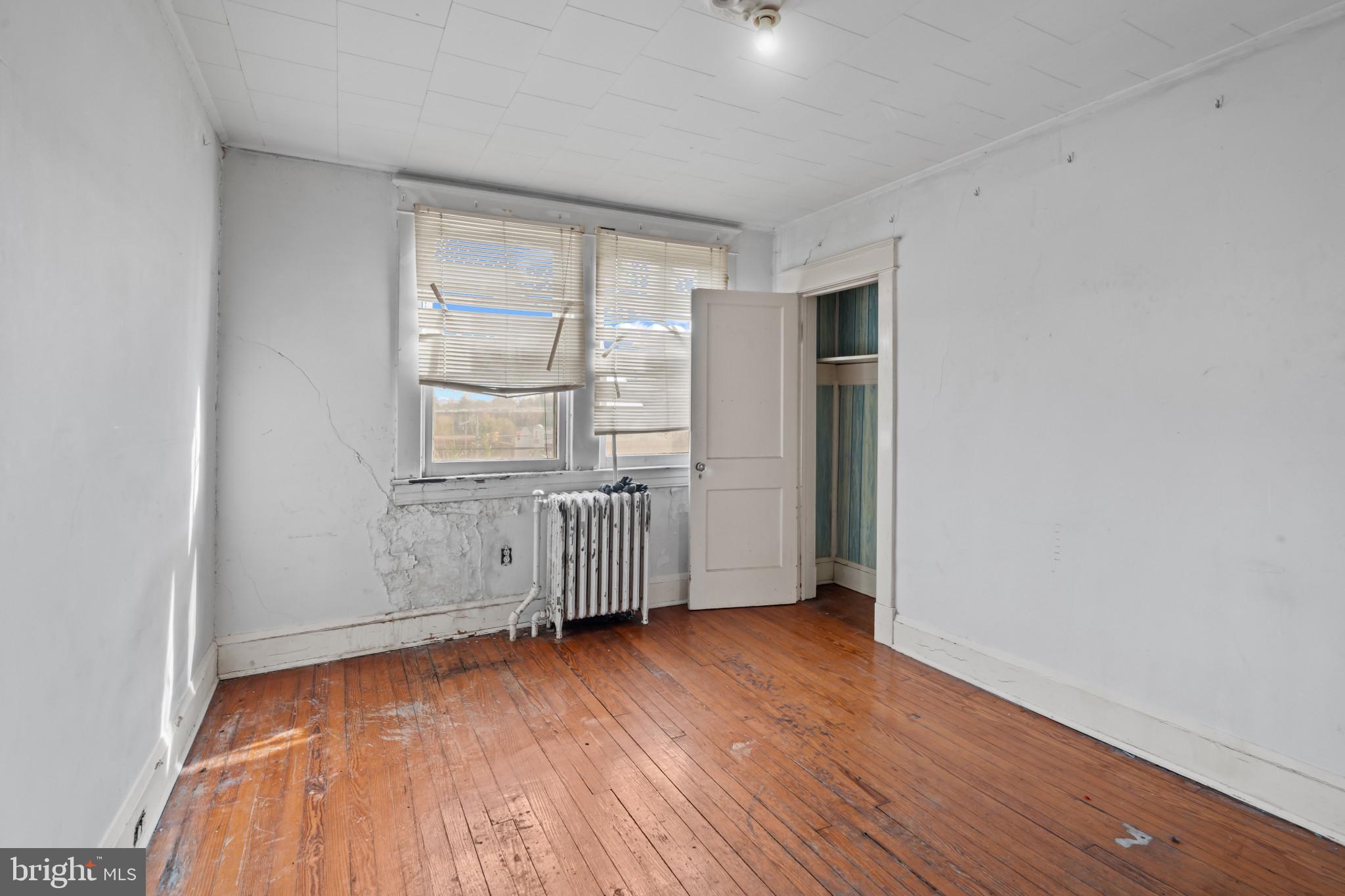 2908 Ailsa Avenue Baltimore, MD 21214 - Photo 19 of 29 an empty room with wooden floor and windows