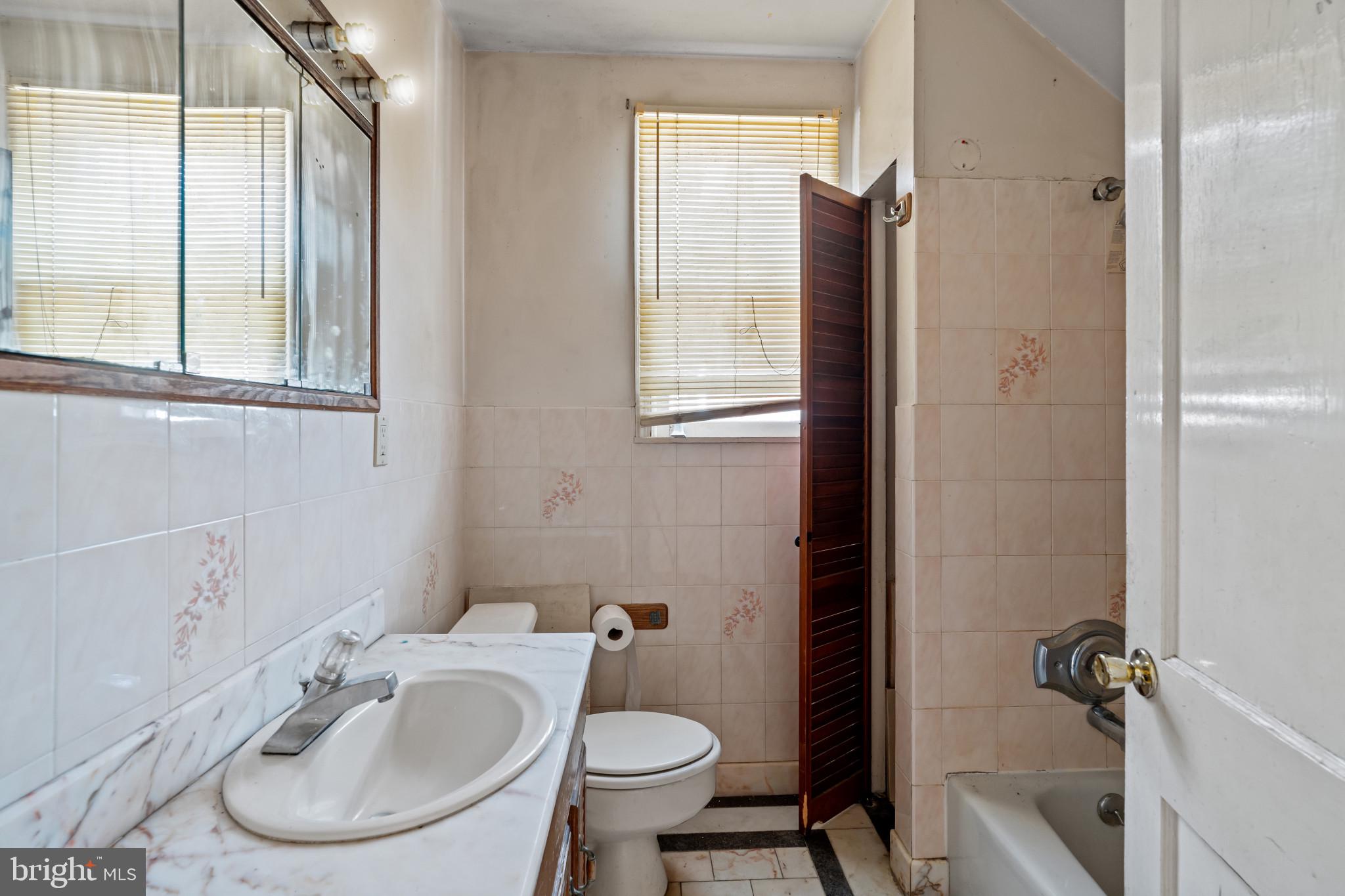 2908 Ailsa Avenue Baltimore, MD 21214 - Photo 21 of 29 a bathroom with a sink toilet and shower
