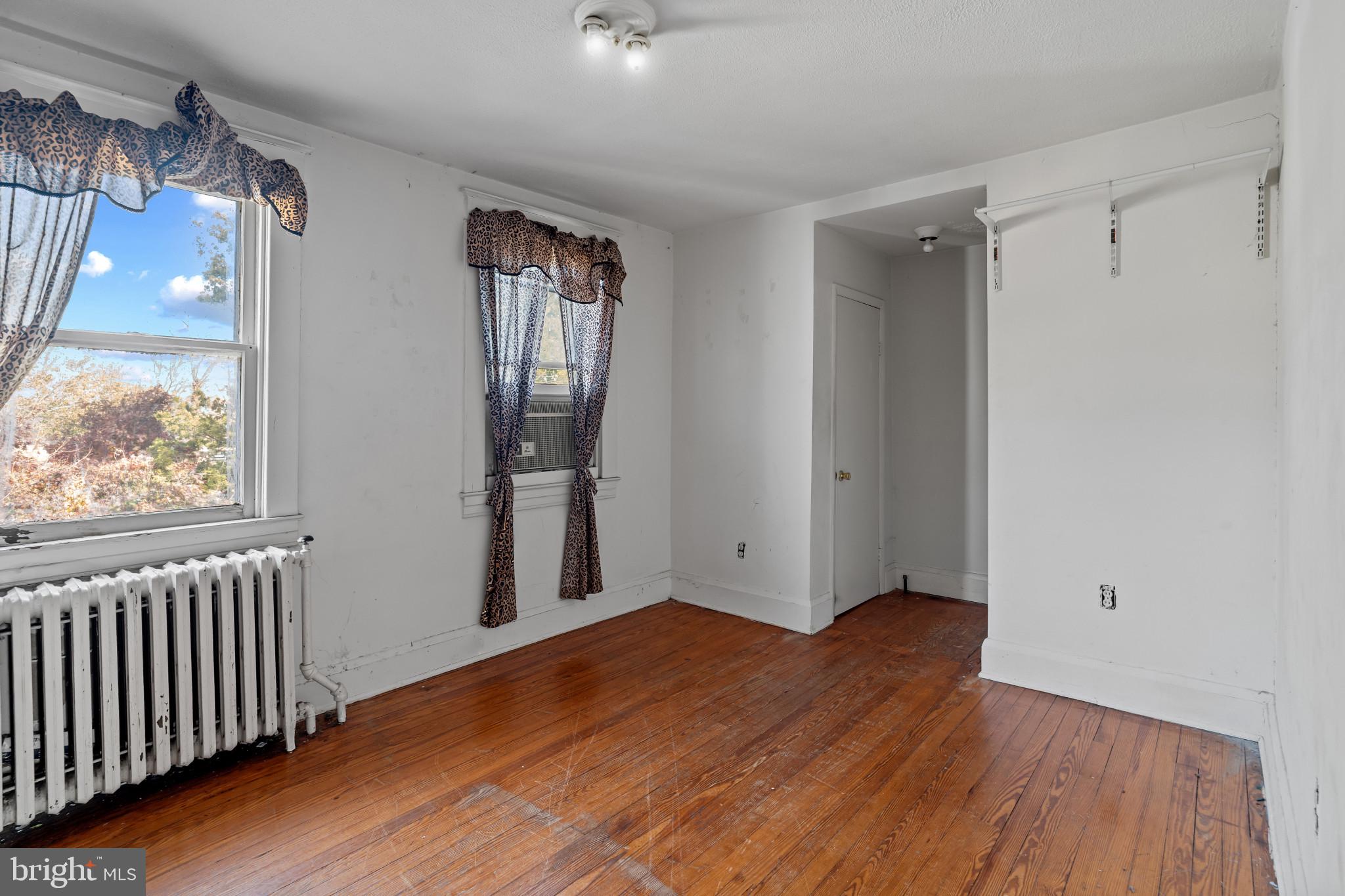 2908 Ailsa Avenue Baltimore, MD 21214 - Photo 22 of 29 a view of empty room with wooden floor and fan